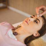 woman-at-crystal-healing-session-in-therapy-room