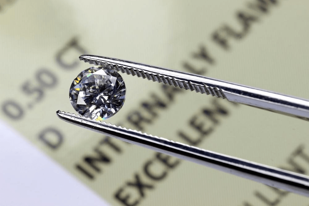 A diamond is closely inspected to determine its clarity rating