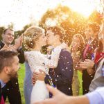 newlywed-couple-and-their-friends-at-the-wedding-party-showered